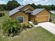 Charming single-story home featuring a manicured lawn and an attached two-car garage at 830 Cabaret Ct, Kissimmee, FL 34759