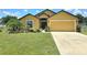 Inviting one-story home with a well-manicured lawn and colorful landscaping at 830 Cabaret Ct, Kissimmee, FL 34759