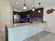 Spacious kitchen island with dark wood cabinets, and granite countertops at 830 Cabaret Ct, Kissimmee, FL 34759