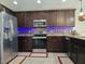 Updated kitchen with stainless steel appliances and stylish tile backsplash at 830 Cabaret Ct, Kissimmee, FL 34759