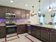 Well-equipped kitchen featuring stainless steel appliances and stone backsplash at 830 Cabaret Ct, Kissimmee, FL 34759