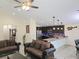 Open-concept space with dark wood cabinets and stainless appliances viewed from the living area at 830 Cabaret Ct, Kissimmee, FL 34759
