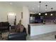 Open living area featuring a kitchen with granite counters and stainless appliances at 830 Cabaret Ct, Kissimmee, FL 34759