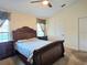A spacious bedroom boasts a large window with a view, a ceiling fan, and neutral-toned walls that brighten the room at 830 Cabaret Ct, Kissimmee, FL 34759