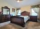 This room features a gorgeous wood bedroom set, complemented by abundant natural light from the two windows at 830 Cabaret Ct, Kissimmee, FL 34759