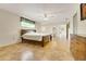 Bright bedroom with tile floors, ceiling fan, dresser, and closet at 8314 W Lake Marion Rd, Haines City, FL 33844
