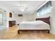 Well-lit bedroom with tile floors, ceiling fan, dresser, and exterior window at 8314 W Lake Marion Rd, Haines City, FL 33844