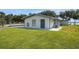 Inviting single story home with blue door, grassy lawn and waterfront views at 8314 W Lake Marion Rd, Haines City, FL 33844