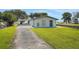Attractive single story home featuring a spacious driveway, and waterfront access at 8314 W Lake Marion Rd, Haines City, FL 33844