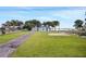 Exterior view of a quaint home with mature trees and a sprawling front lawn at 8314 W Lake Marion Rd, Haines City, FL 33844