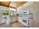 Kitchen with appliances, wood ceiling, and views to the outdoors at 8314 W Lake Marion Rd, Haines City, FL 33844