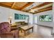 Cozy living room with wood ceiling, tile floors, and large windows with view at 8314 W Lake Marion Rd, Haines City, FL 33844