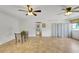 Open living room with tile flooring, fans, and access to hallway and view at 8314 W Lake Marion Rd, Haines City, FL 33844