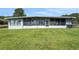 View of a spacious screened patio overlooking a well-maintained lawn and waterfront at 8314 W Lake Marion Rd, Haines City, FL 33844