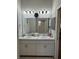 Well-lit bathroom featuring double sinks, a large mirror, and neutral finishes for a bright and functional space at 832 Vienna Dr, Winter Haven, FL 33884