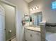 Bathroom with a single sink vanity and a corner soaking tub at 832 Vienna Dr, Winter Haven, FL 33884