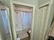 Bathroom with a bathtub with shower, toilet, and closet with louvered doors at 832 Vienna Dr, Winter Haven, FL 33884