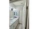 Bathroom with double sinks, white cabinets, modern lighting, and a view of the toilet room at 832 Vienna Dr, Winter Haven, FL 33884