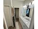 Spacious bathroom with double sinks, long vanity, and a view into the hallway at 832 Vienna Dr, Winter Haven, FL 33884