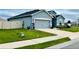 Well-maintained house showcases a manicured lawn, a spacious driveway, and a tidy landscape design at 832 Vienna Dr, Winter Haven, FL 33884