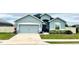 Charming single-story home featuring a two-car garage, well-manicured lawn, and inviting front entrance at 832 Vienna Dr, Winter Haven, FL 33884