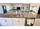 Spacious kitchen island with sink and granite countertops, offering additional seating and workspace at 832 Vienna Dr, Winter Haven, FL 33884
