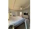 This main bedroom features tray ceilings, neutral paint, light flooring, and a doorway to the en-suite bathroom at 832 Vienna Dr, Winter Haven, FL 33884