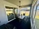 Screened-in patio with a table and chairs. A ceiling fan provides air circulation at 832 Vienna Dr, Winter Haven, FL 33884
