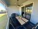 Screened-in patio with a table and chairs and a grill. A ceiling fan provides air circulation at 832 Vienna Dr, Winter Haven, FL 33884