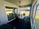 Screened-in patio with a table and chairs. A ceiling fan provides air circulation at 832 Vienna Dr, Winter Haven, FL 33884