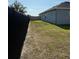 A fenced in side yard with small grass area at 832 Vienna Dr, Winter Haven, FL 33884