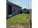 A fenced in side yard with small grass area at 832 Vienna Dr, Winter Haven, FL 33884