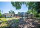 The spacious backyard includes a screened-in pool area, shade trees, and a sunny lawn at 961 Oleander Se Dr, Winter Haven, FL 33880