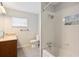 Neutral bathroom with a tub/shower combo, wood vanity and updated fixtures at 961 Oleander Se Dr, Winter Haven, FL 33880
