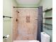 Bathroom featuring a tiled shower with an ornate inset, toilet and dark shelving at 961 Oleander Se Dr, Winter Haven, FL 33880