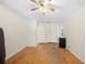 Spacious bedroom with hardwood floors, ceiling fan, closet, and bright windows at 961 Oleander Se Dr, Winter Haven, FL 33880