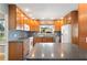 Updated kitchen featuring a tile backsplash, stainless steel appliances, and an island with granite countertops at 961 Oleander Se Dr, Winter Haven, FL 33880
