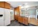 Functional kitchen featuring ample cabinetry, an island, tile floor, and access to the backyard at 961 Oleander Se Dr, Winter Haven, FL 33880
