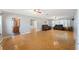 Spacious living room features wood floors, neutral paint, and access to the kitchen and dining areas at 961 Oleander Se Dr, Winter Haven, FL 33880