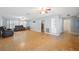 Open living room with hardwood floors, ceiling fans, and ample natural light from large windows at 961 Oleander Se Dr, Winter Haven, FL 33880