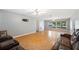 Bright living area with wood floors, neutral walls, ceiling fan, and large windows offering a view at 961 Oleander Se Dr, Winter Haven, FL 33880