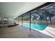 An inviting screened-in pool area features a bright in-ground pool, a sunroom, and stylish outdoor lighting at 961 Oleander Se Dr, Winter Haven, FL 33880