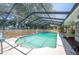 A large in-ground pool features a screened-in structure, access ladder, and a spacious sundeck at 961 Oleander Se Dr, Winter Haven, FL 33880