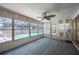 Enclosed sunroom featuring a ceiling fan and overlooking the pool at 961 Oleander Se Dr, Winter Haven, FL 33880