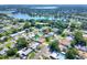 Scenic aerial view showcasing a neighborhood with backyard pools, mature trees, and lake views at 961 Piedmont Se Dr, Winter Haven, FL 33880