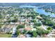 Aerial view showcasing the property in a neighborhood with community lake at 961 Piedmont Se Dr, Winter Haven, FL 33880