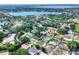 Overhead view of a residential neighborhood with mature trees and proximity to a serene lake at 961 Piedmont Se Dr, Winter Haven, FL 33880