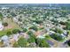 Aerial view of a home in a mature neighborhood featuring tree lined streets at 961 Piedmont Se Dr, Winter Haven, FL 33880