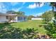 Backyard featuring lush lawn, privacy fence, and Florida room at 961 Piedmont Se Dr, Winter Haven, FL 33880