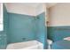 Retro bathroom featuring aqua tiles around the bathtub and matching vanity at 961 Piedmont Se Dr, Winter Haven, FL 33880